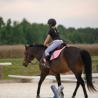 Girl Riding horse in periwinkle leggings