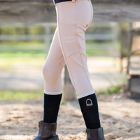 Girl in equestrian clothes wearing riding leggings and boot socks