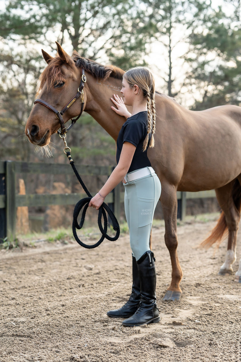 Girl holding pony wearing Soft sage leggings
