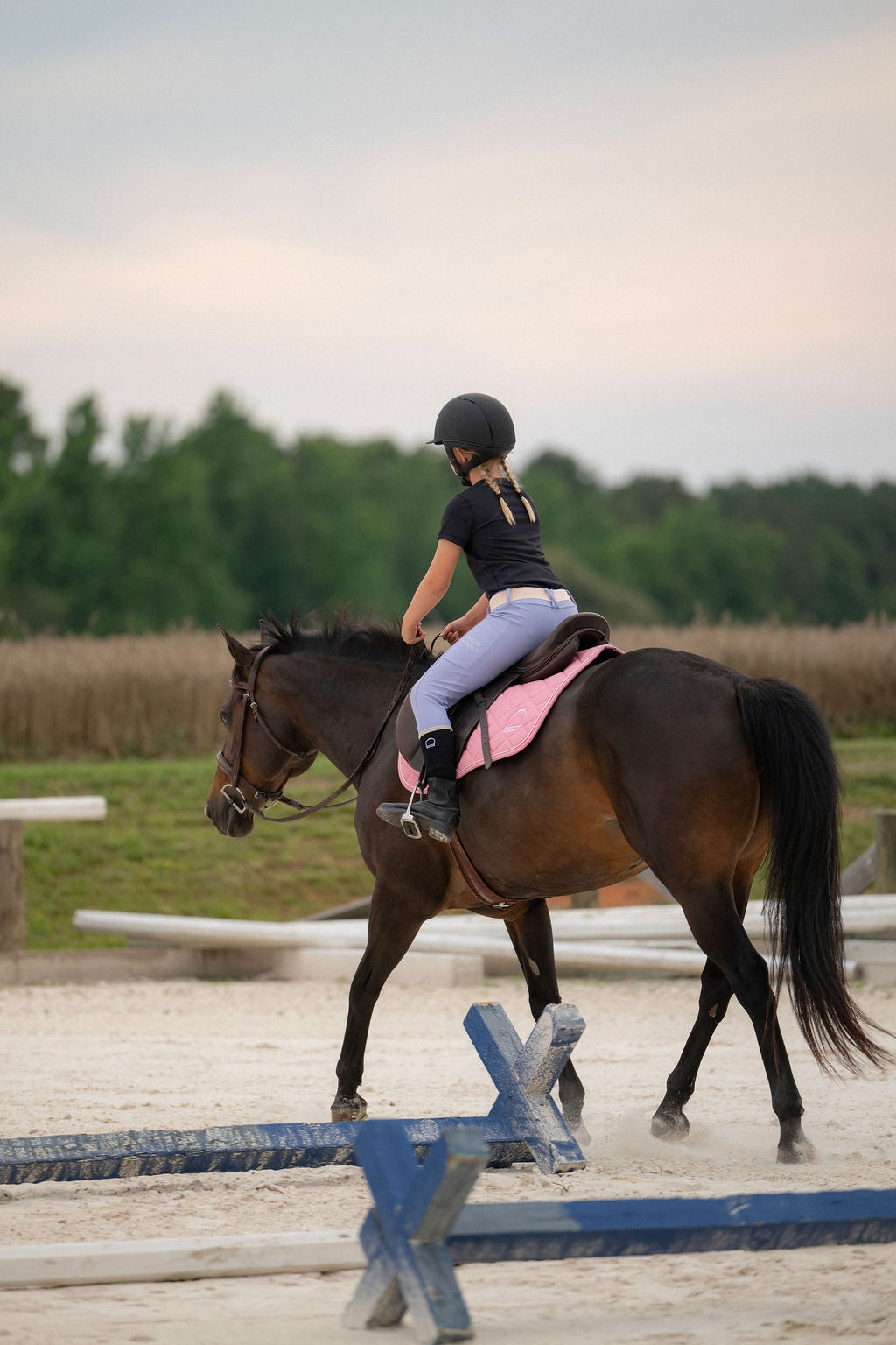 Girl Riding horse in periwinkle leggings