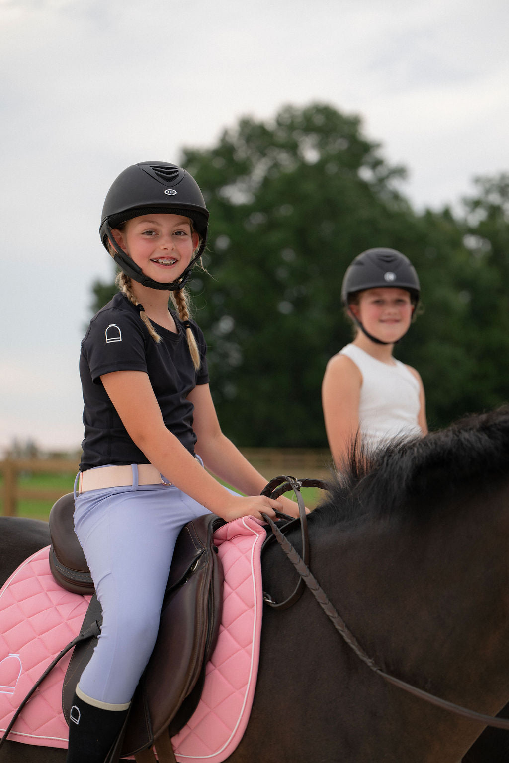 Girl riding horse in equestrian leggings